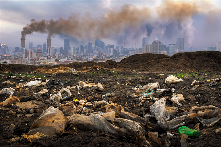 Pile of toxic waste with a city in the background