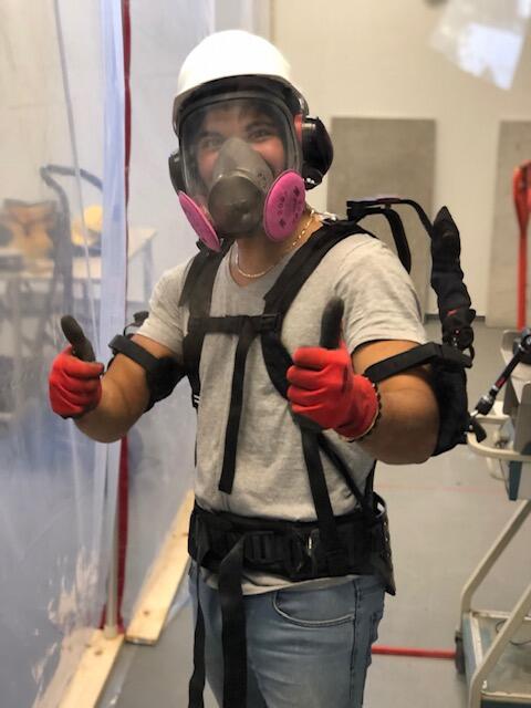 Man in exoskeleton at construction site giving a thumbs up