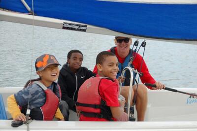 Kids on a sail boat smiling